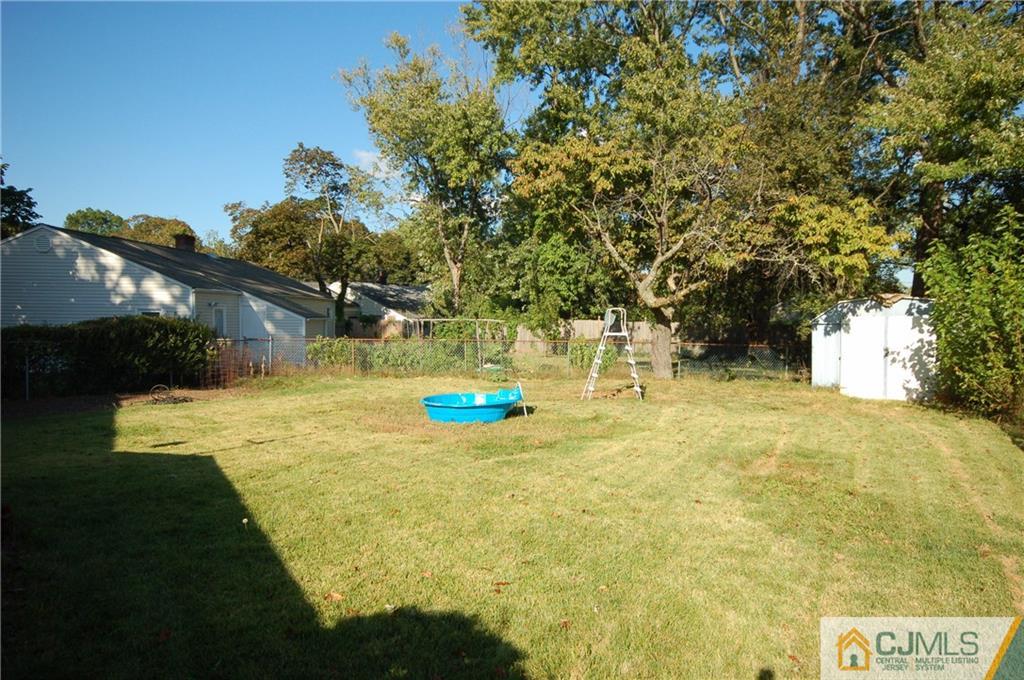 33 Stony Road Edison, NJ 08817 - Photo 23 of 25 a swimming pool with some trees in the background