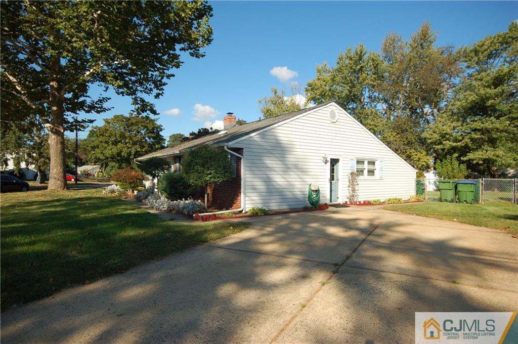 33 Stony Road Edison, NJ 08817 - Photo 24 of 25 a view of a white house next to a yard and road