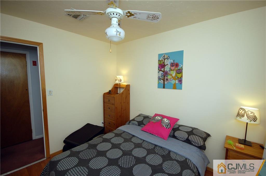 33 Stony Road Edison, NJ 08817 - Photo 4 of 25 a bedroom with a bed and a dresser