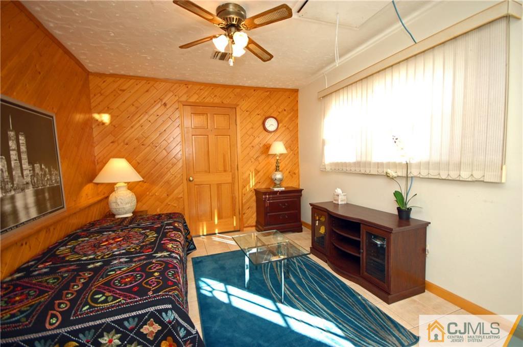 33 Stony Road Edison, NJ 08817 - Photo 9 of 25 a bed room with a bed and a chandelier