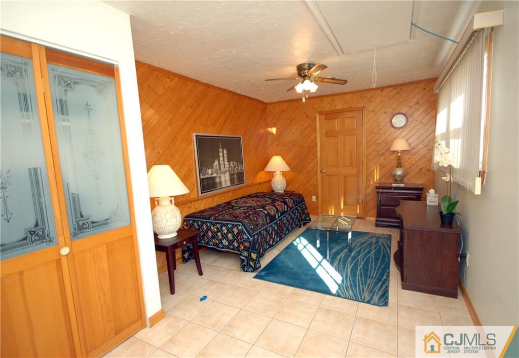 33 Stony Road Edison, NJ 08817 - Photo 10 of 25 a bedroom with a bed and wooden floor