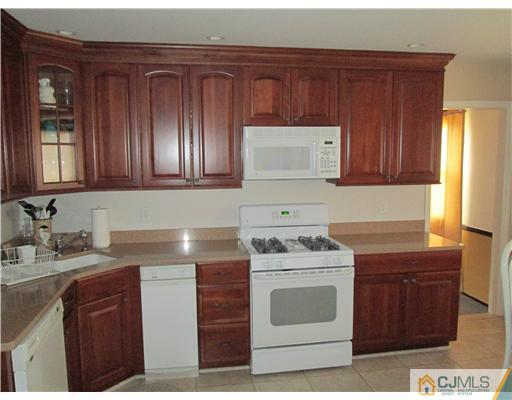 120 South Cliff Road Colonia, NJ 07067 - Photo 2 of 13 a kitchen with sink cabinets and window