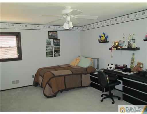 120 South Cliff Road Colonia, NJ 07067 - Photo 6 of 13 a bedroom with a bed and cabinets