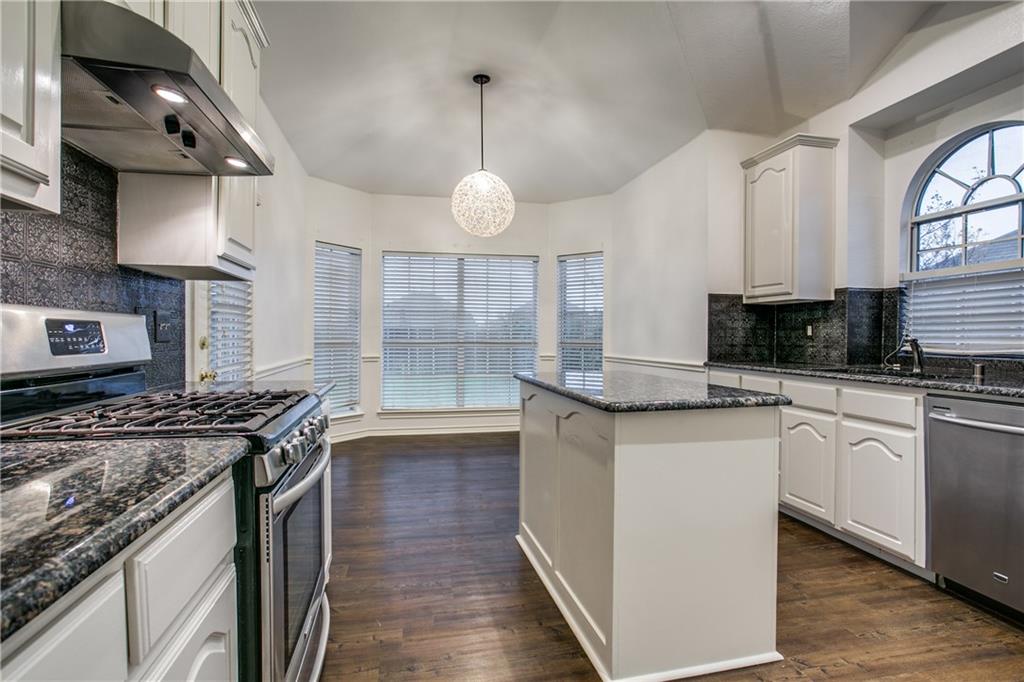 2105 Cardinal Drive Forney, TX 75126 - Photo 1 of 1 a kitchen with stainless steel appliances granite countertop a stove a sink and a microwave