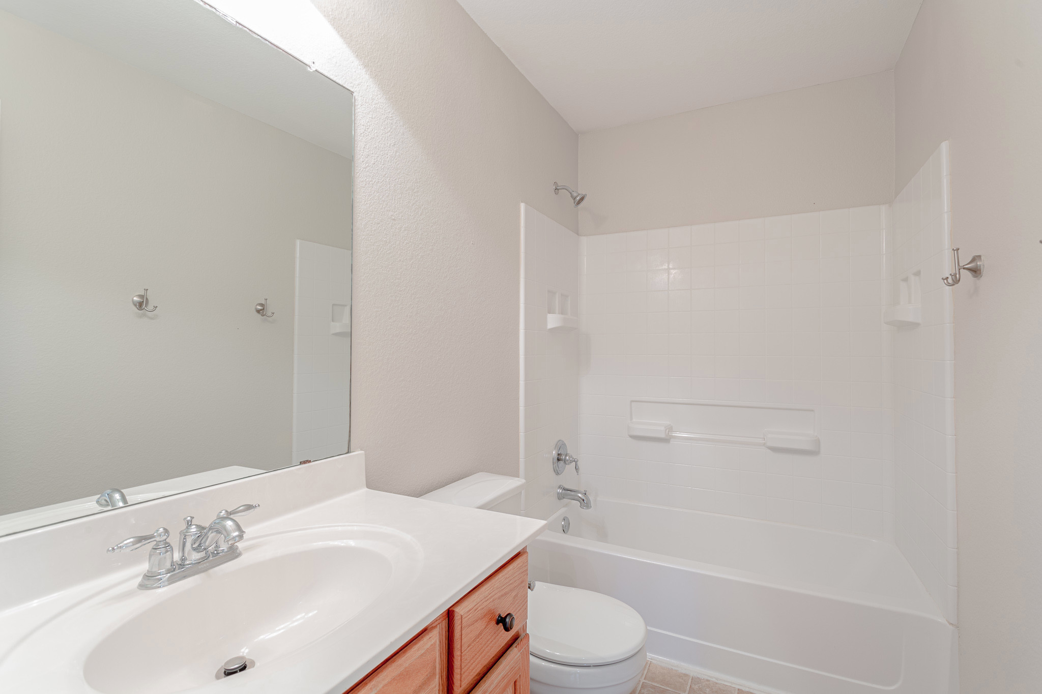 19201 Mangan Way Pflugerville, TX 78660 - Photo 21 of 29 Bathroom featuring vanity, shower / tub combination, and light tile patterned floors