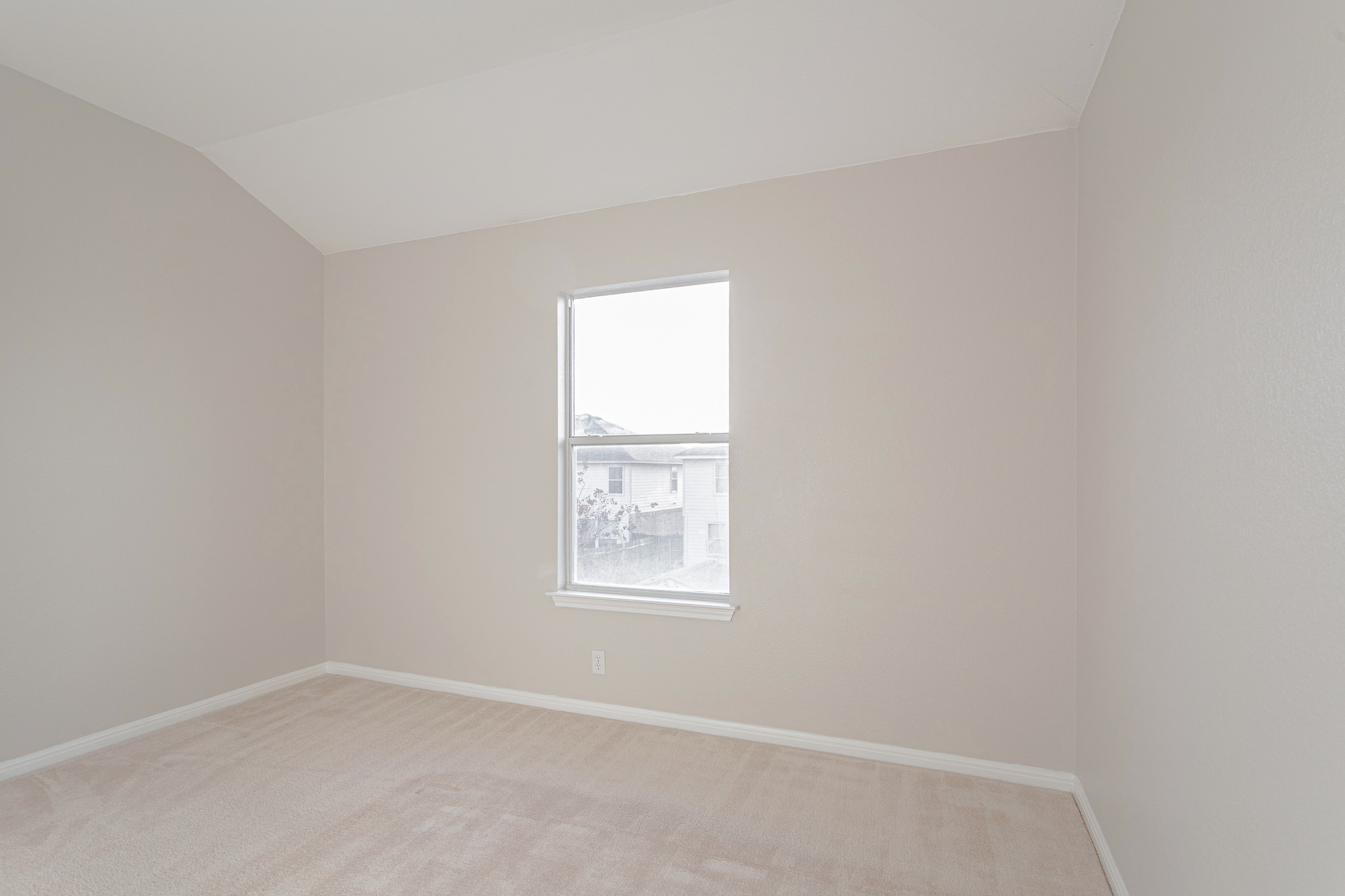 19201 Mangan Way Pflugerville, TX 78660 - Photo 10 of 29 Unfurnished room featuring light carpet and vaulted ceiling