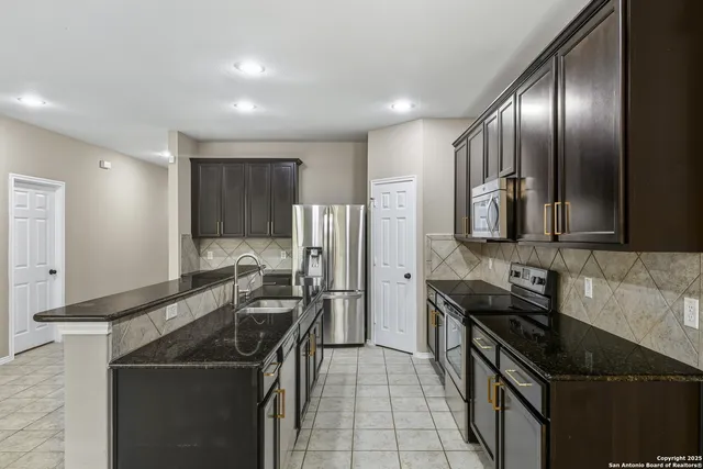 a kitchen that has a sink and a stove