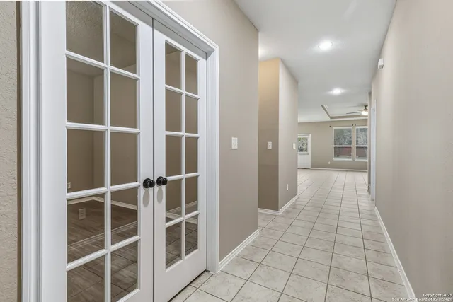 a view of a hallway with wooden floor and a large window