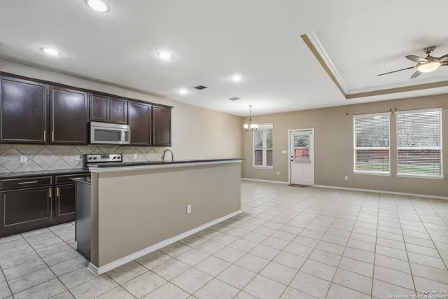 a view of kitchen with microwave and cabinets