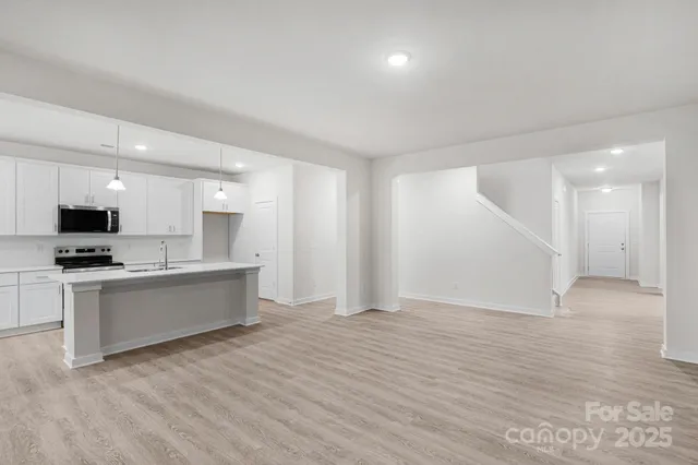 a view of kitchen with microwave and wooden floor