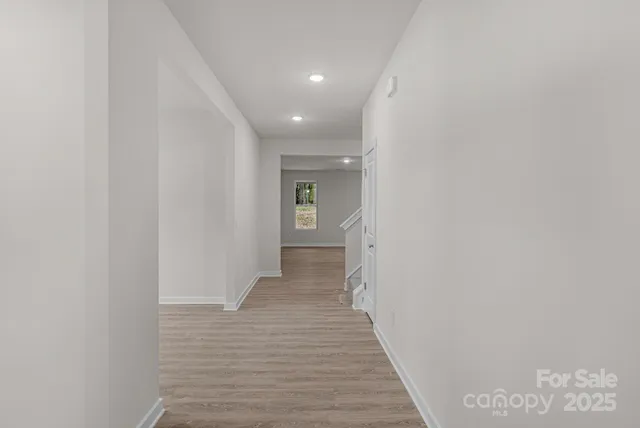 a view of a hallway with wooden floor