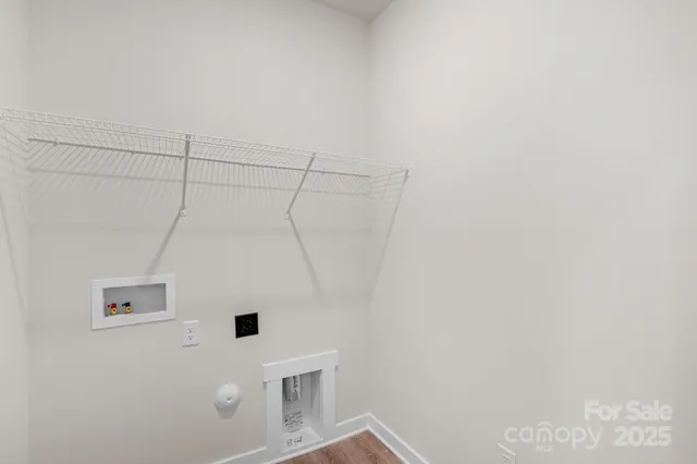 a view of a utility room with a refrigerator
