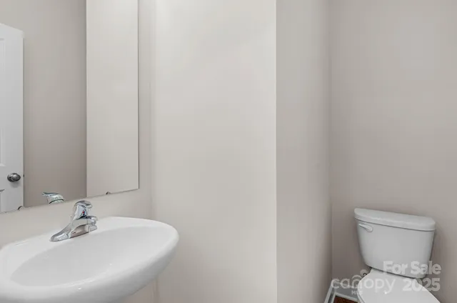 a bathroom with a sink a toilet and mirror