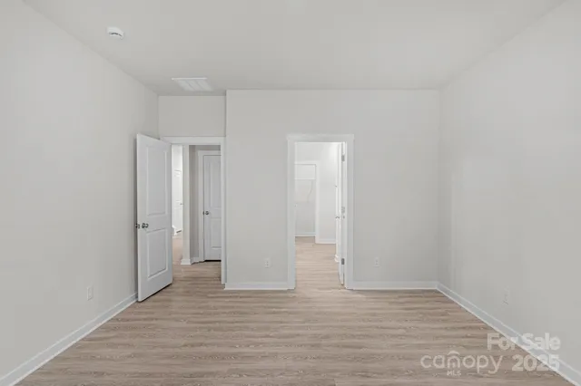 a view of an empty room and wooden floor