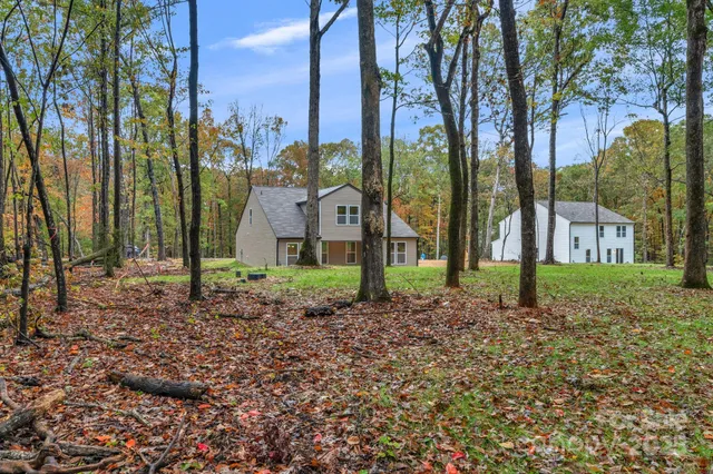 a view of a house with a yard and garage
