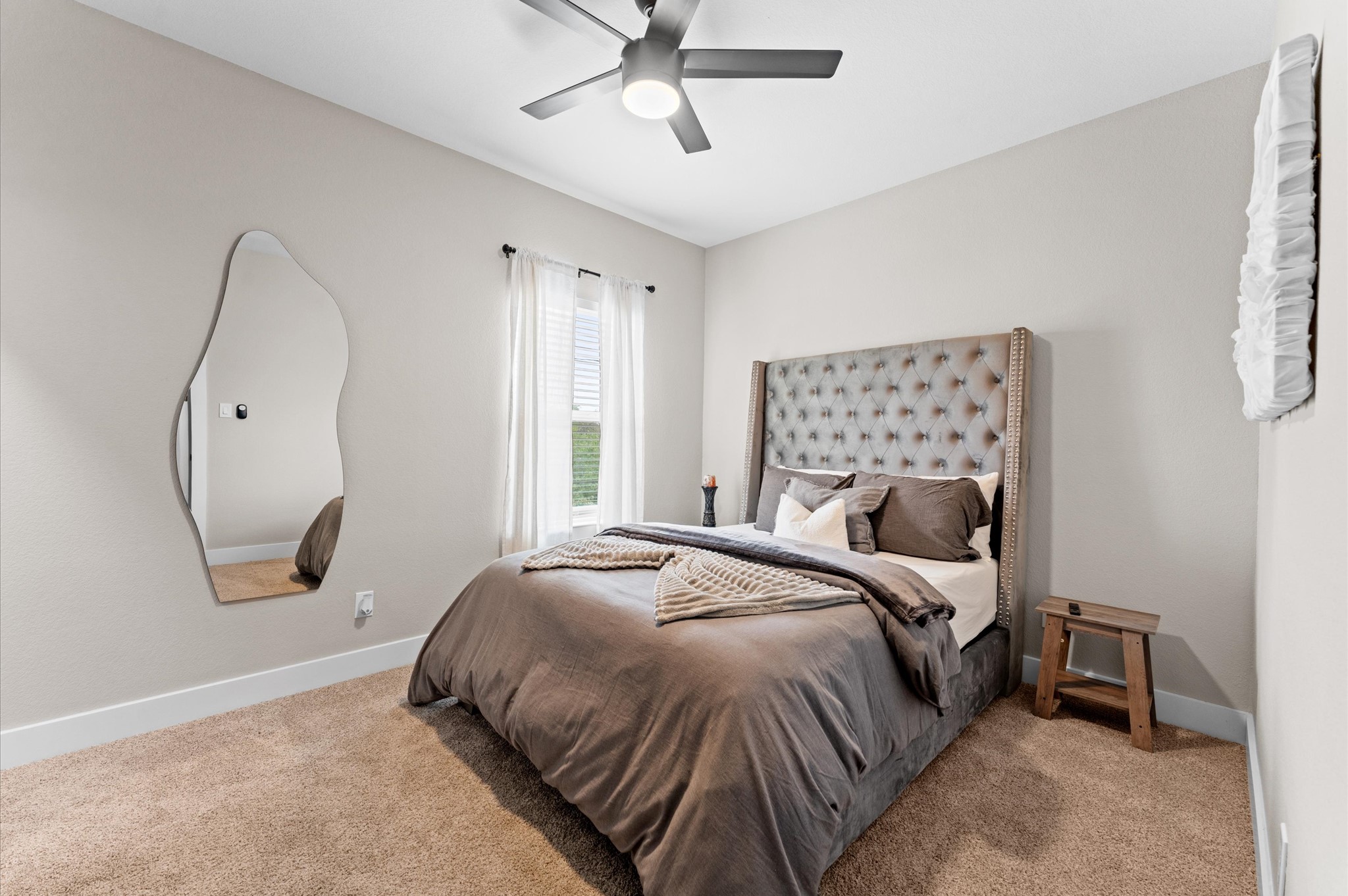 6904 Covington Drive, Unit B Houston, TX 77091 - Photo 19 of 47 a bedroom with a bed a mirror and a window