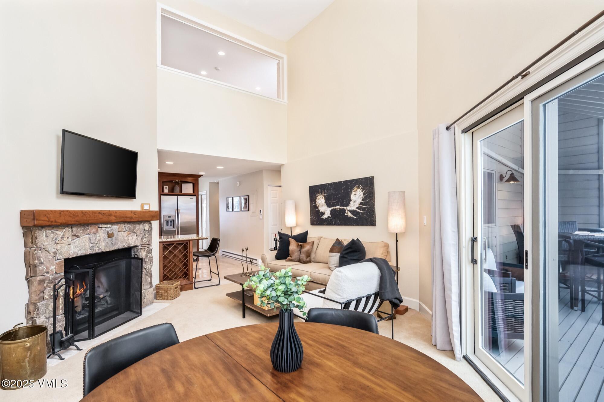 945 Red Sandstone Road, Unit A5 Vail, CO 81657 - Photo 3 of 38 a living room with furniture a flat screen tv and a fireplace