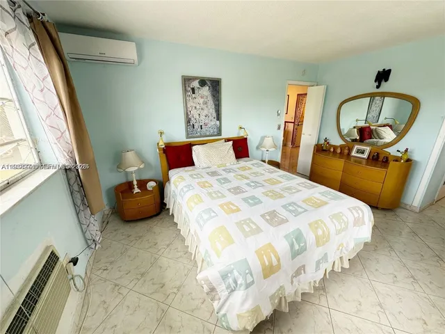 a bedroom with bed and window