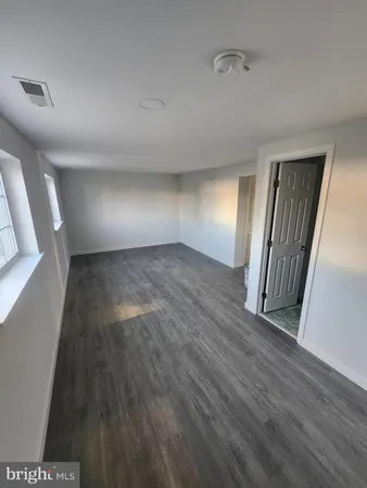 a view of an empty room and wooden floor