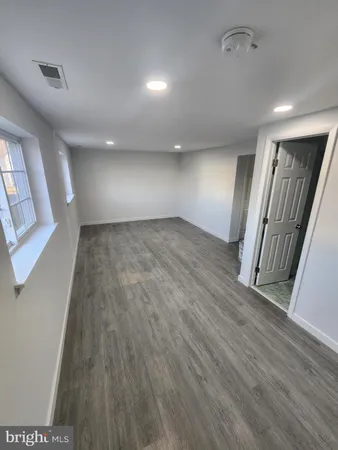 wooden floor in an empty room with a mirror