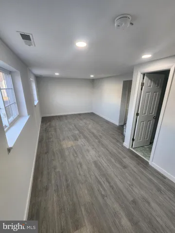 wooden floor in an empty room with a mirror