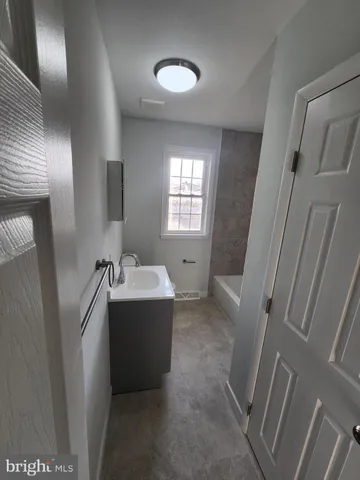 a view of bathroom with bathtub and shower