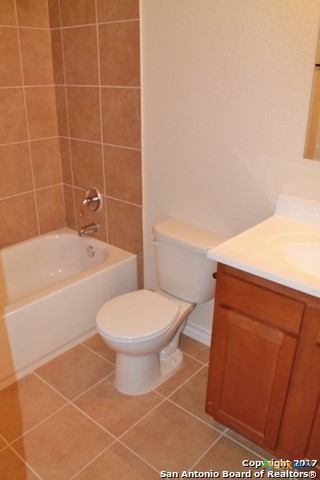 16845 Showdown Path, Unit 2 Selma, TX 78154 - Photo 12 of 16 a bathroom with a toilet a sink and bathtub