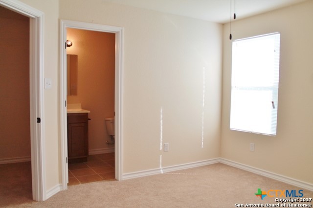 16845 Showdown Path, Unit 2 Selma, TX 78154 - Photo 13 of 16 a view of an empty room with closet and a window