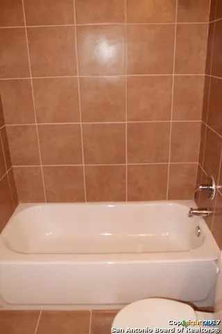 a bathroom with a sink toilet and mirror