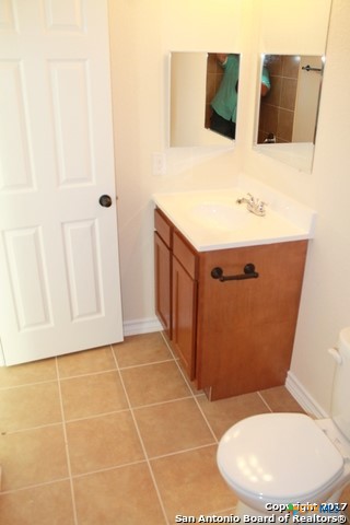 16845 Showdown Path, Unit 2 Selma, TX 78154 - Photo 16 of 16 a bathroom with a sink toilet and mirror