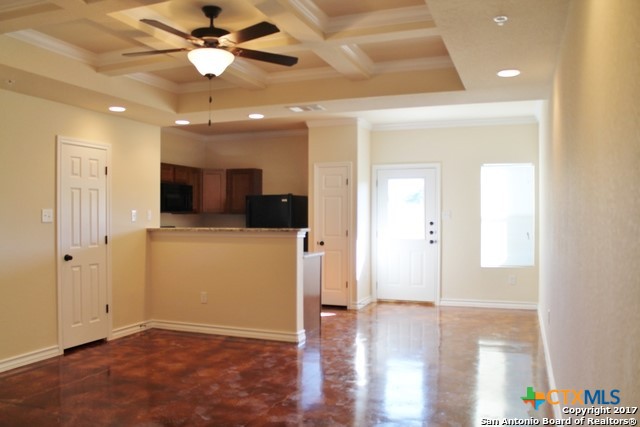 16845 Showdown Path, Unit 2 Selma, TX 78154 - Photo 2 of 16 a view of a hallway with wooden floor and a ceiling fan