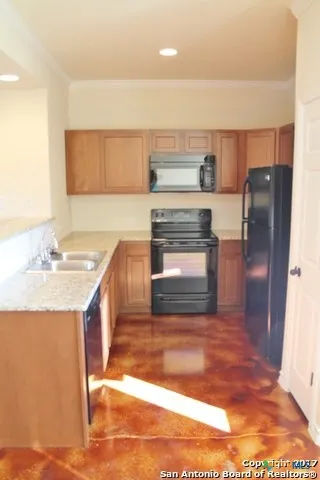a kitchen with a refrigerator sink and stove
