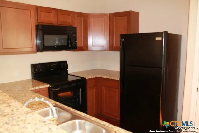 a kitchen with a refrigerator and cabinets
