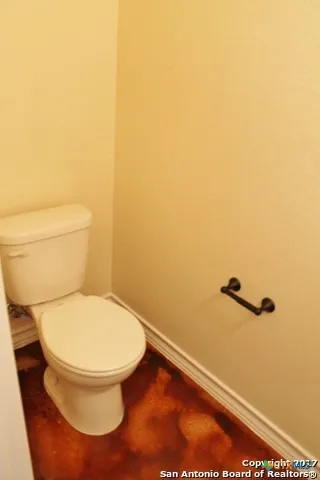 a bathroom with a toilet and a view