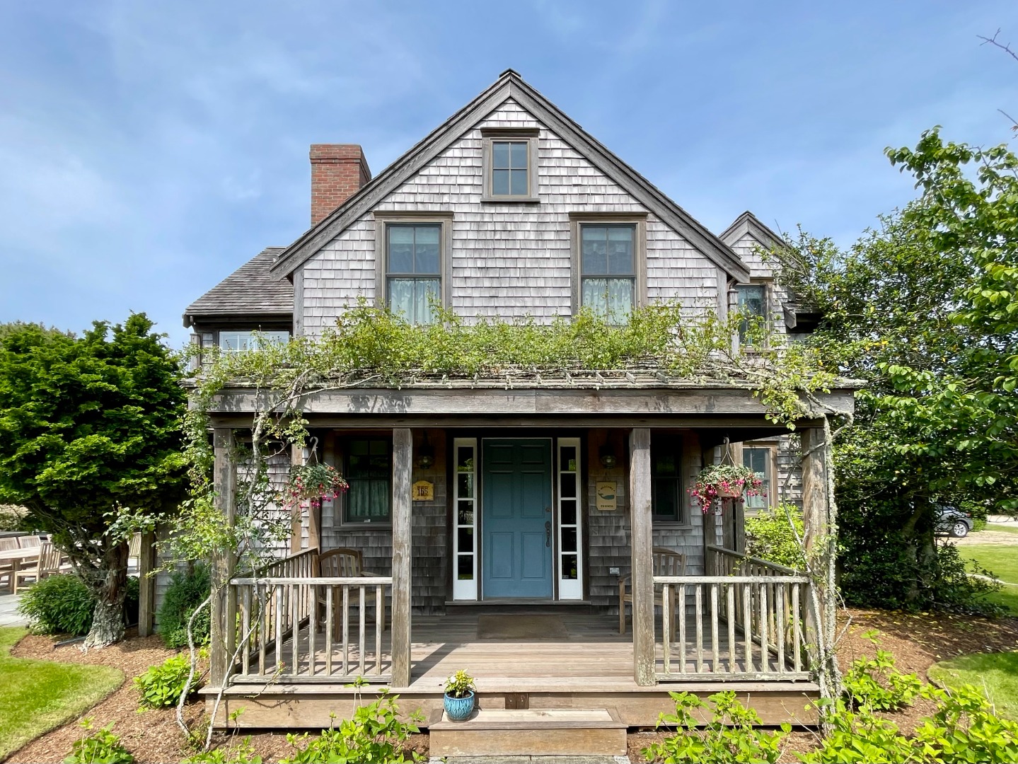 155 Surfside Road Nantucket, MA 02554 - Photo 3 of 60 a front view of a house with garden