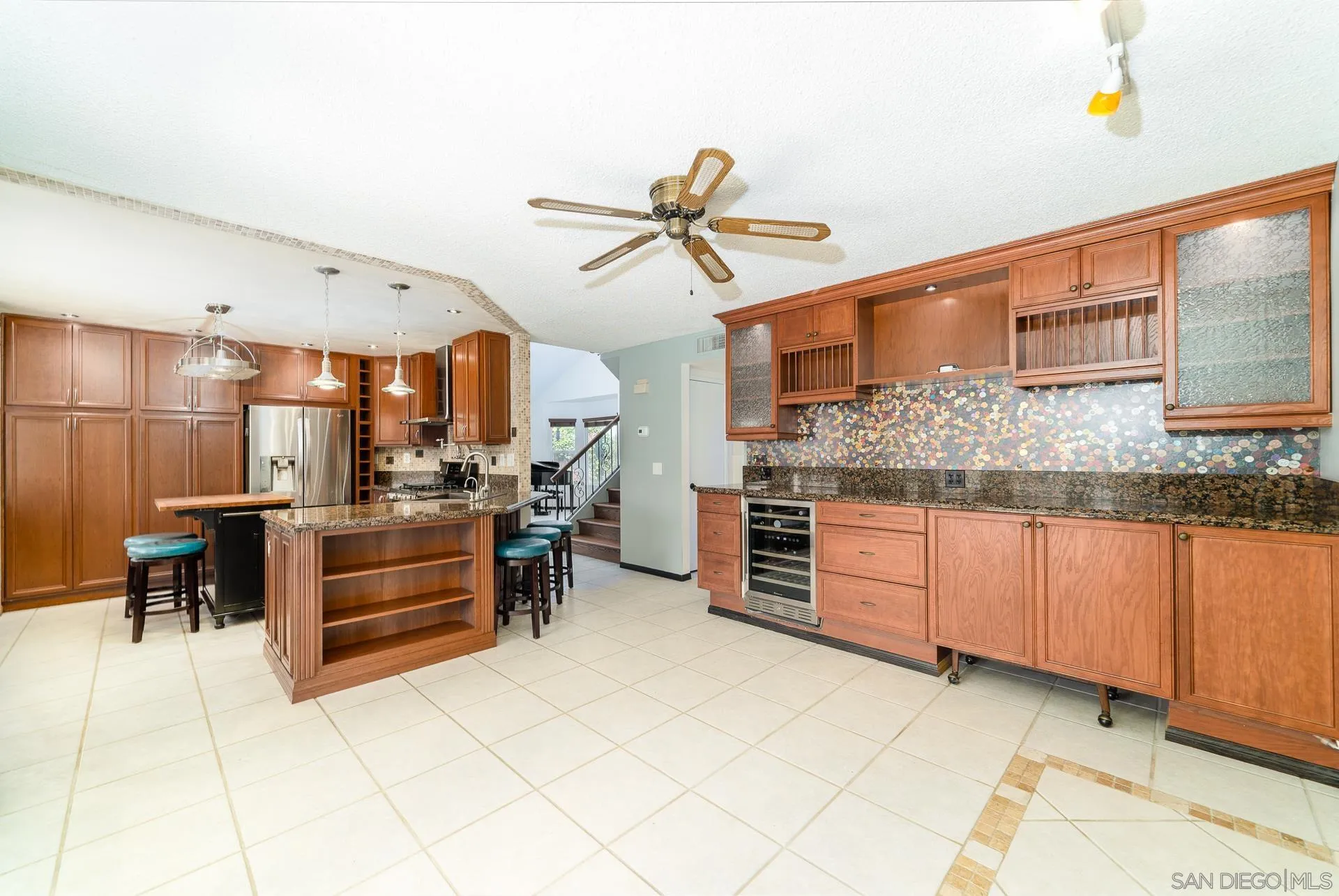 5268 Champlain Street Oceanside, CA 92056 - Photo 12 of 40 a kitchen with stainless steel appliances kitchen island granite countertop a stove a cabinets and a sink
