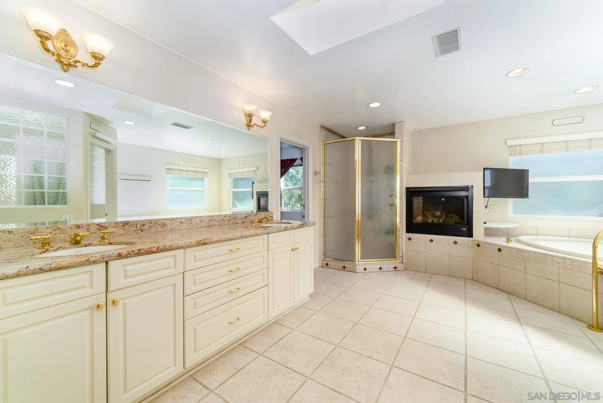 5268 Champlain Street Oceanside, CA 92056 - Photo 22 of 40 a large white bathroom with a granite countertop sink mirror and bathtub