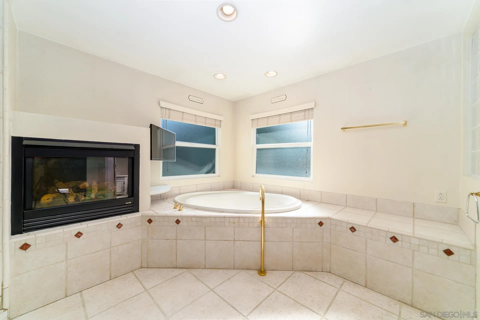 5268 Champlain Street Oceanside, CA 92056 - Photo 23 of 40 a room with white cabinets and flat screen tv