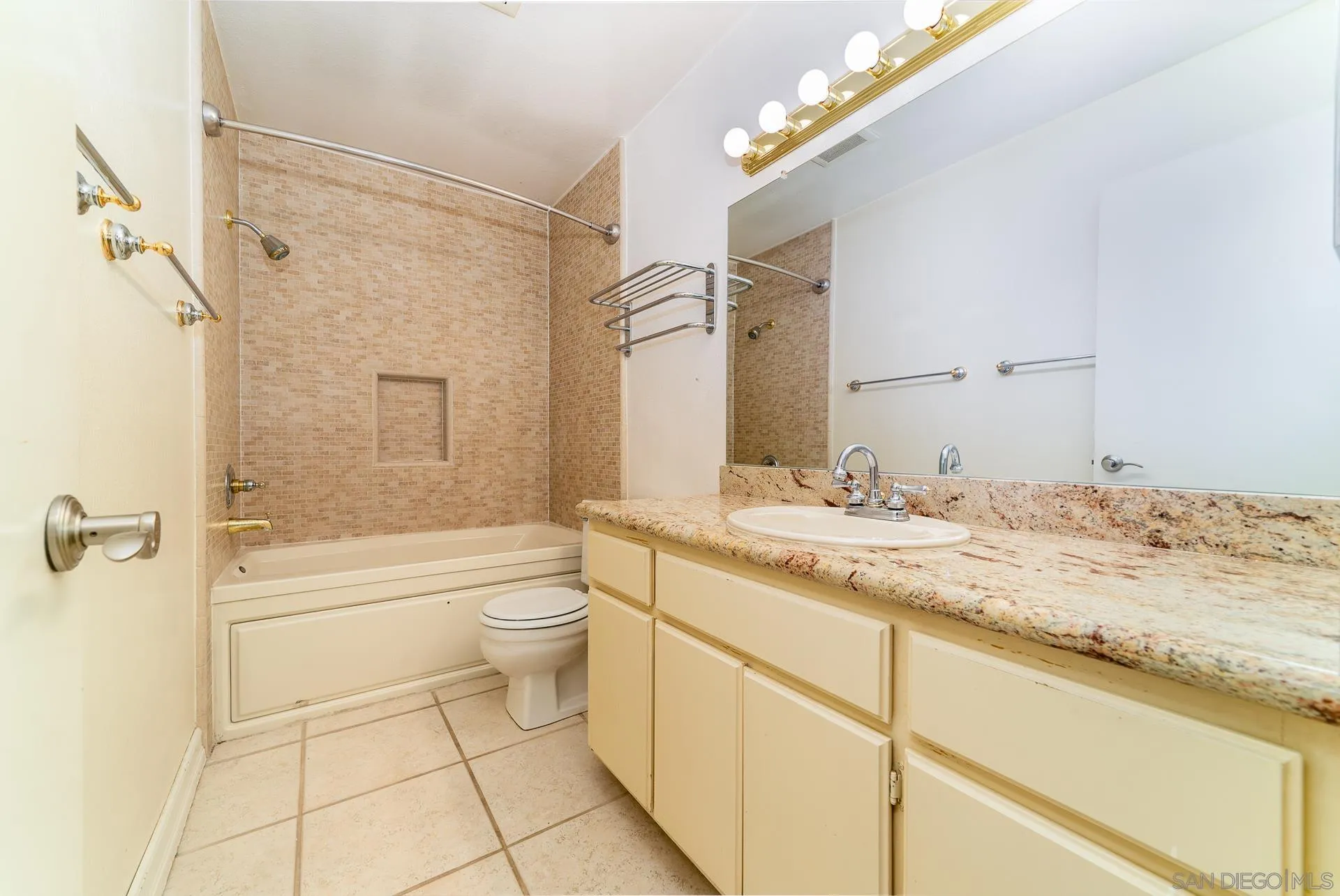 5268 Champlain Street Oceanside, CA 92056 - Photo 32 of 40 a bathroom with a granite countertop sink a toilet and shower