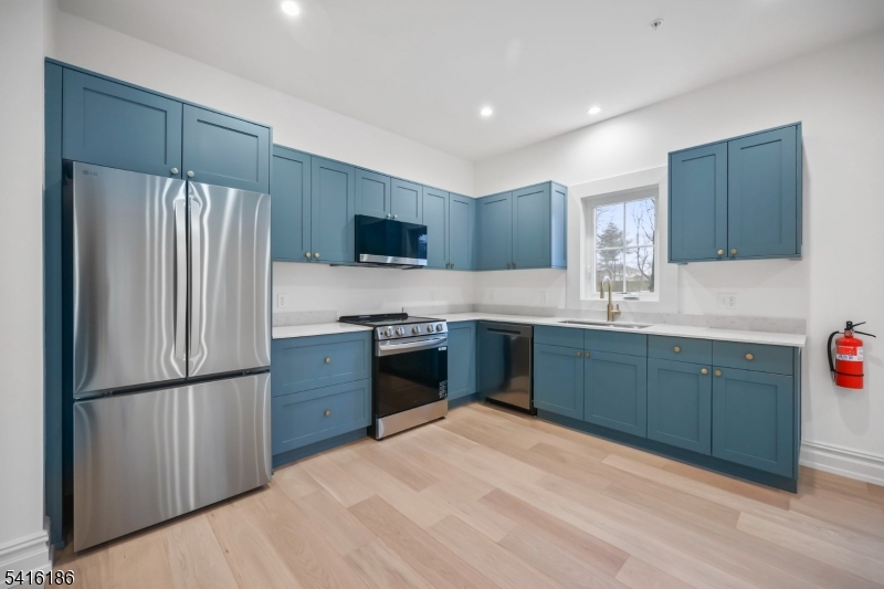 1209 Littleton Road, Unit C Morris Plains, NJ 07950 - Photo 1 of 15 a kitchen with granite countertop stainless steel appliances a refrigerator sink and microwave