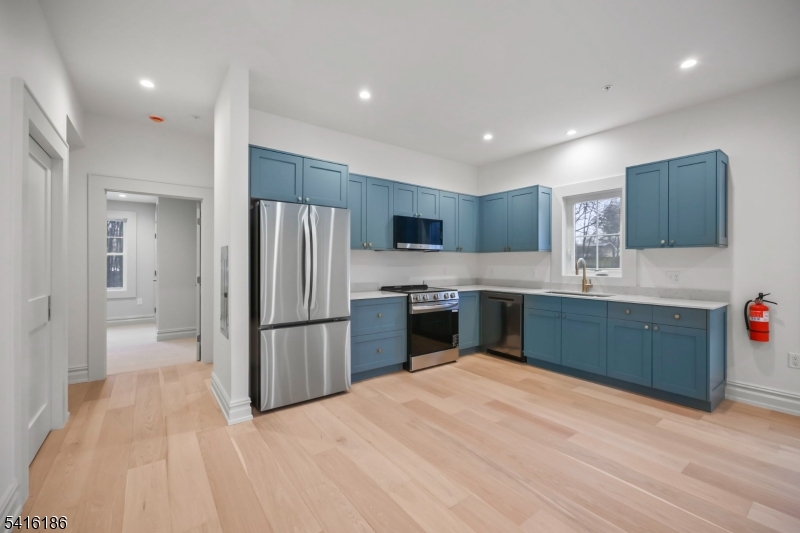 1209 Littleton Road, Unit C Morris Plains, NJ 07950 - Photo 5 of 15 a kitchen with a refrigerator and a sink