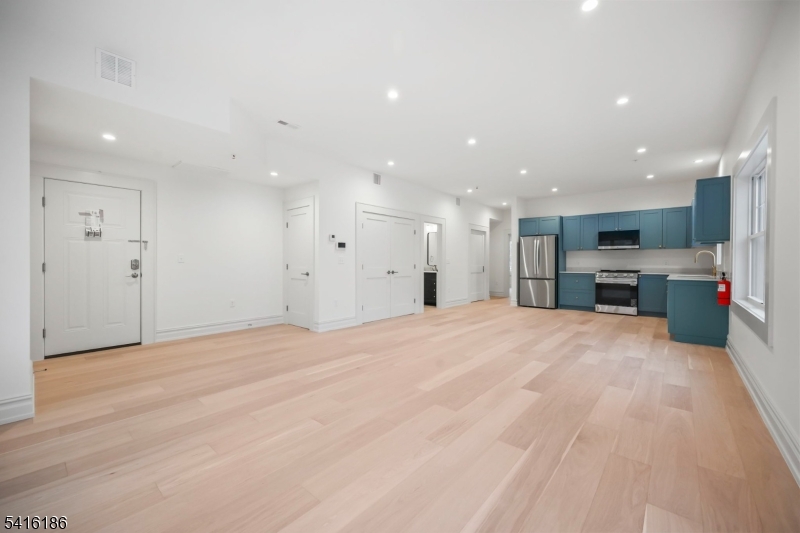 1209 Littleton Road, Unit C Morris Plains, NJ 07950 - Photo 7 of 15 a large kitchen with a large window in it and a kitchen with kitchen island