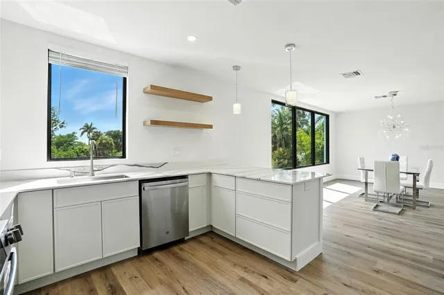 a kitchen with a sink cabinets and window