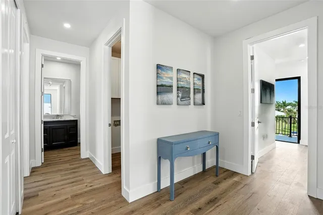 a view of a hallway with wooden floor and closet