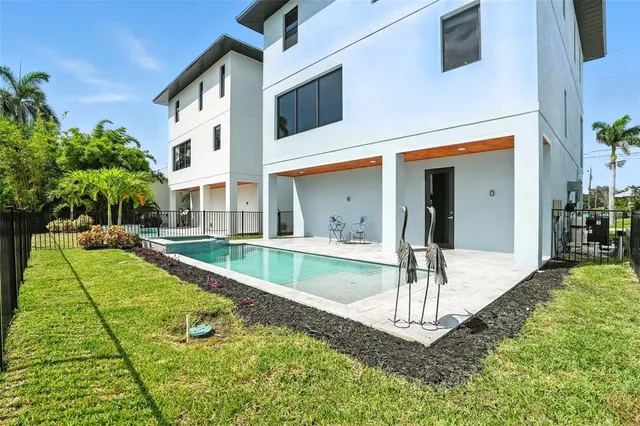 a front view of residential houses with yard and furniture