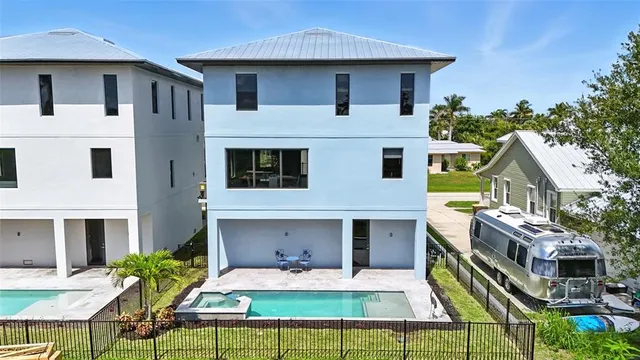 a aerial view of a house with swimming pool garden and patio