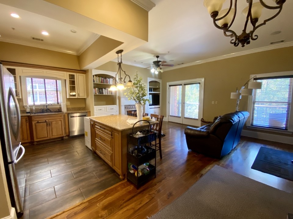 210 West Washington Street, Unit 210 Madison, GA 30650 - Photo 2 of 8 a living room with furniture and a kitchen