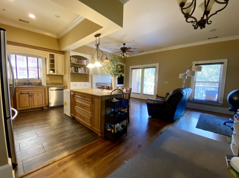 210 West Washington Street, Unit 210 Madison, GA 30650 - Photo 3 of 8 a large living room with stainless steel appliances granite countertop lots of counter top space
