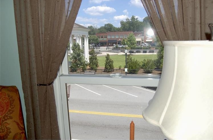 210 West Washington Street, Unit 210 Madison, GA 30650 - Photo 7 of 8 a bathroom with a bathtub