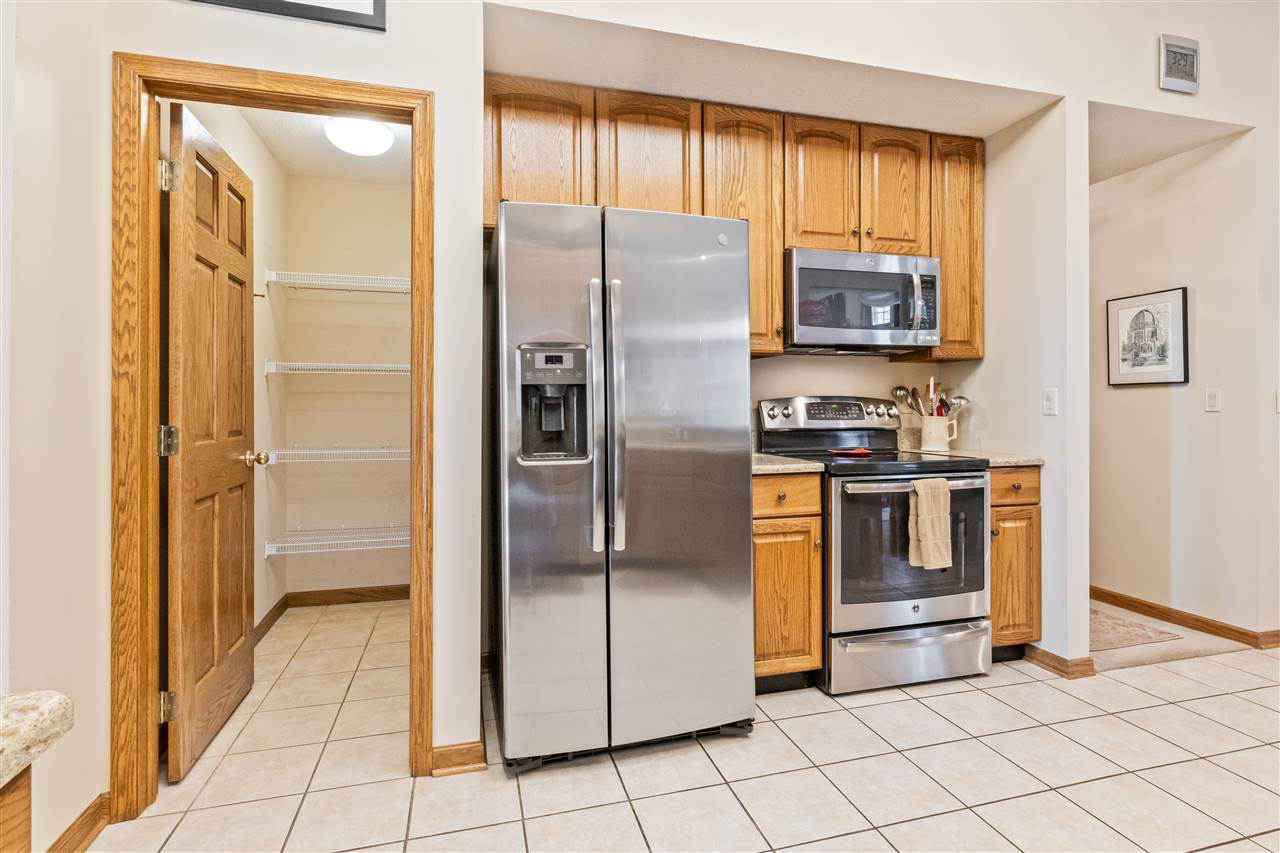 7272 Sentinel Road Rockford, IL 61107 - Photo 11 of 40 a kitchen with stainless steel appliances granite countertop a refrigerator and a stove